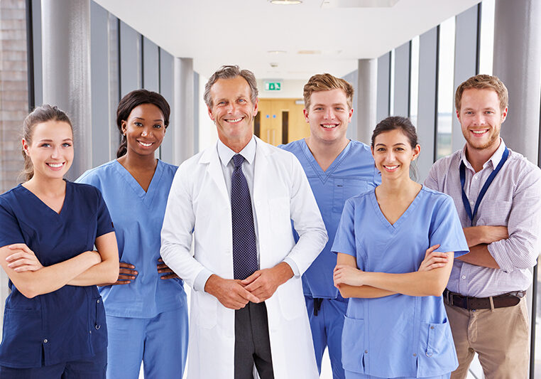 Portrait Of Medical Team Standing In Hospital Corridor Portrait Of Medical Team Standing In Hospital Corridor